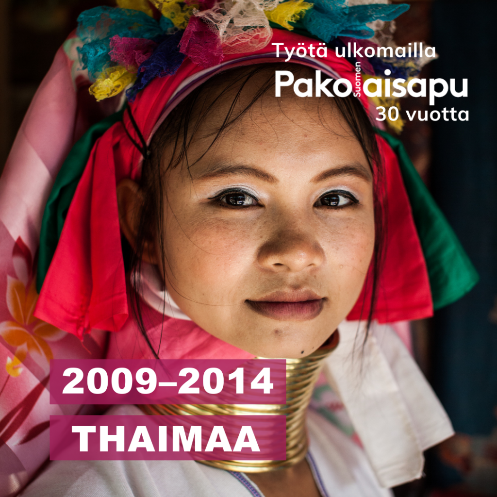 Nainen katsoo kameraan värikkäässä perinneasussa. Kuvassa on Pakolaisapu, työtä ulkomailla 30 vuotta -logo ja teksti 2009-2014 Thaimaa.